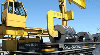 Transloading coil from rail cars to trucks