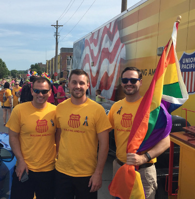 David Black (right) with 2019 BRIDGES President Wes Dooley (center) and his husband, Mike, at a Heartland Pride parade.